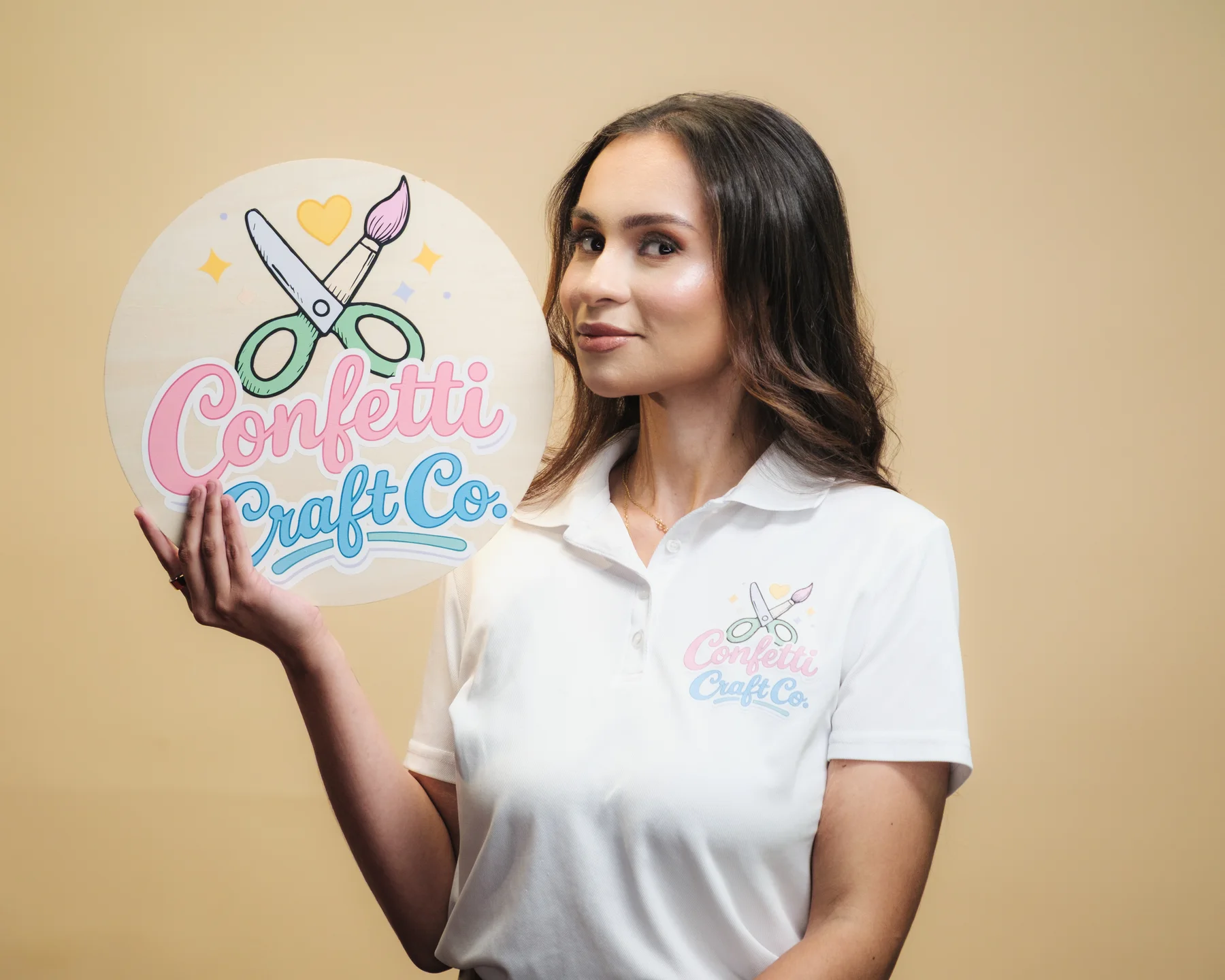 Confetti Craft Co. founder holding a branded sign